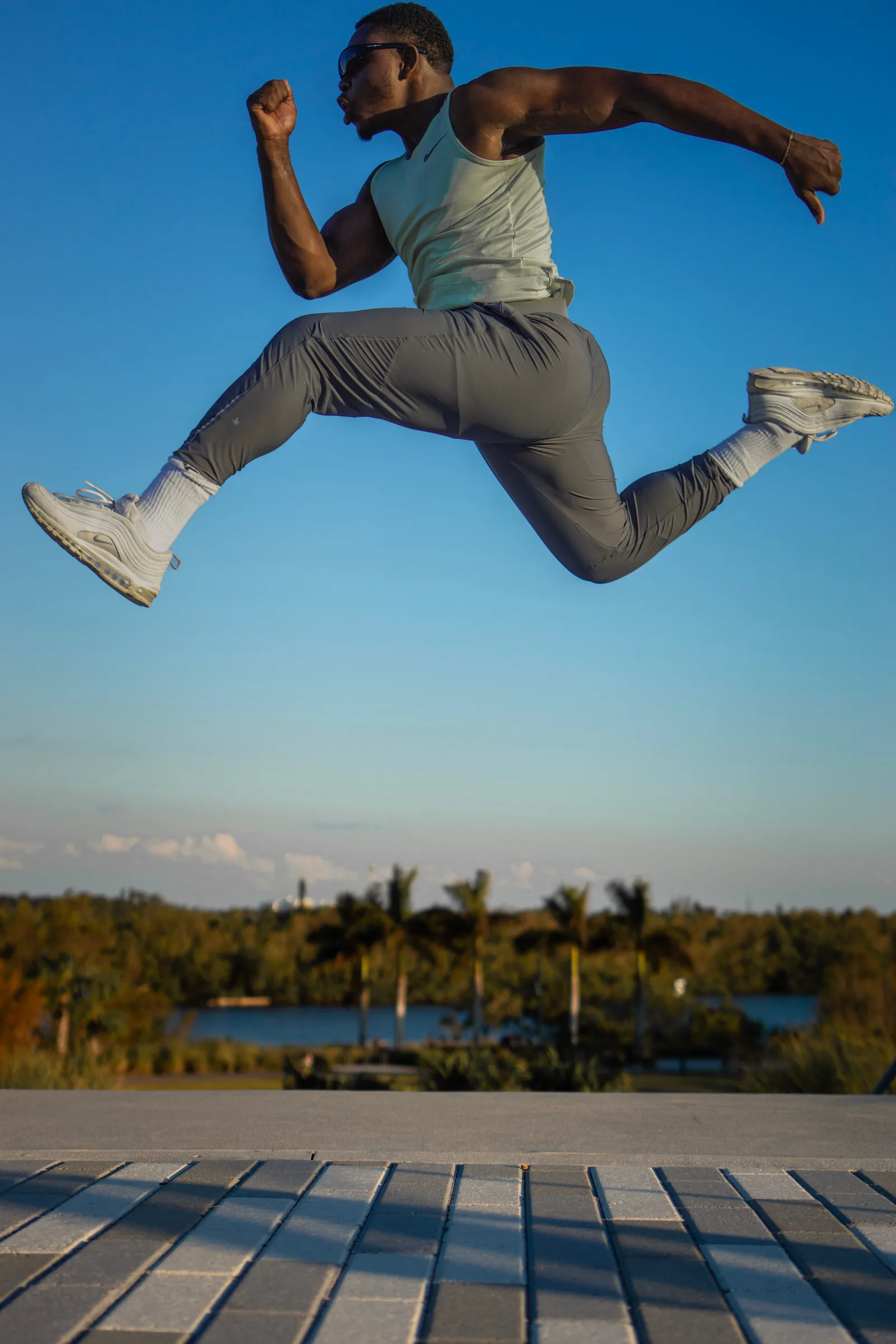 Athlete leaping outdoors against a blue sky
